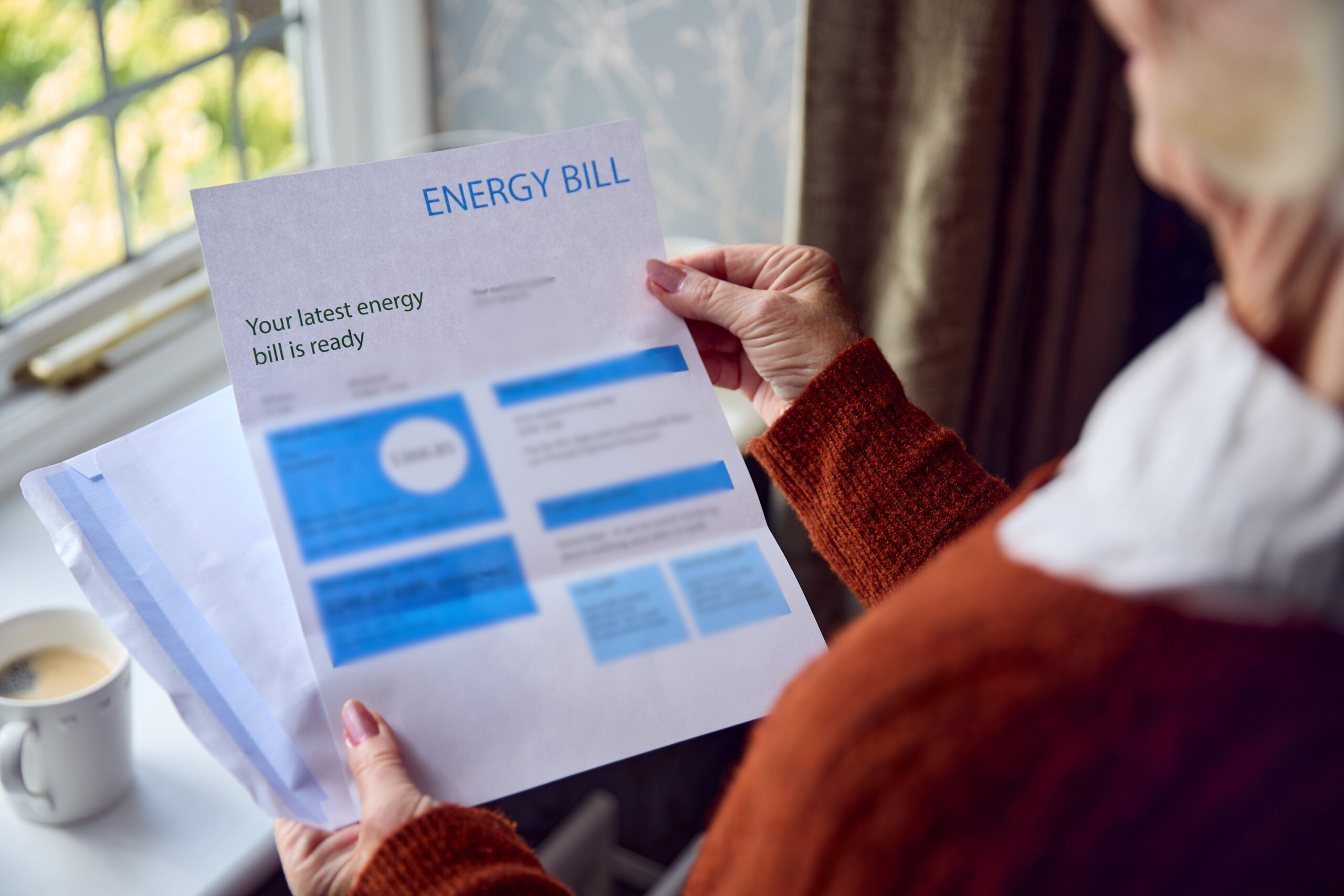 energy bill in a woman's hand