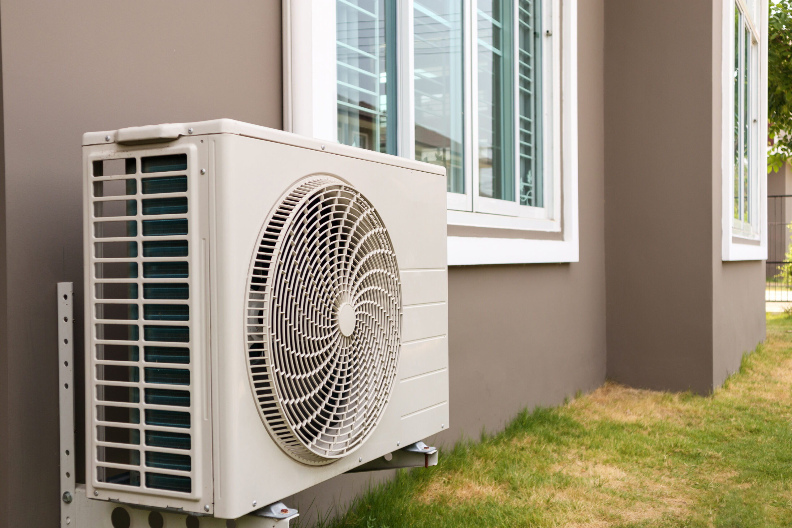 heat pump unit outside a stucco home