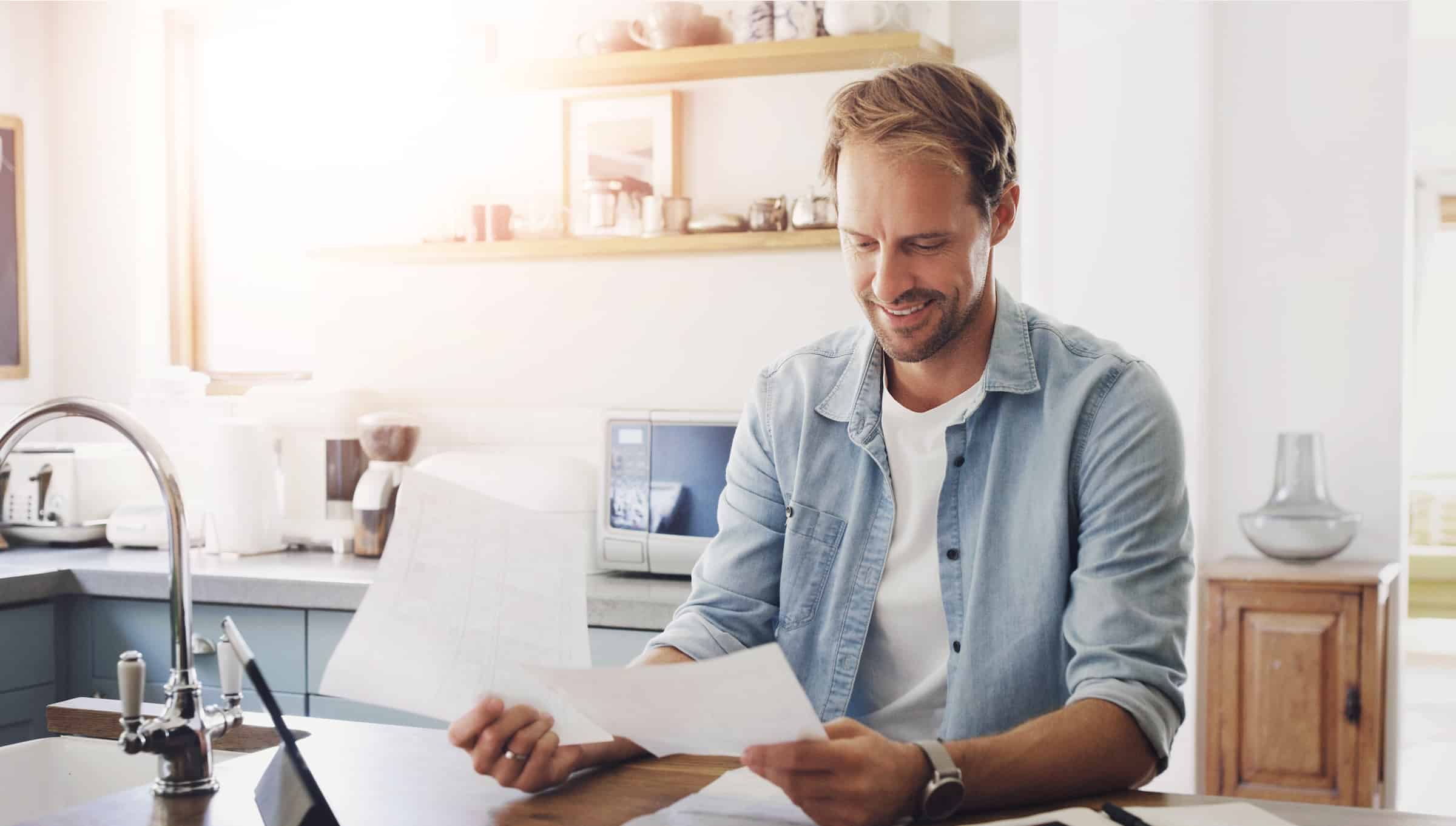 Happy man looking at tax documents